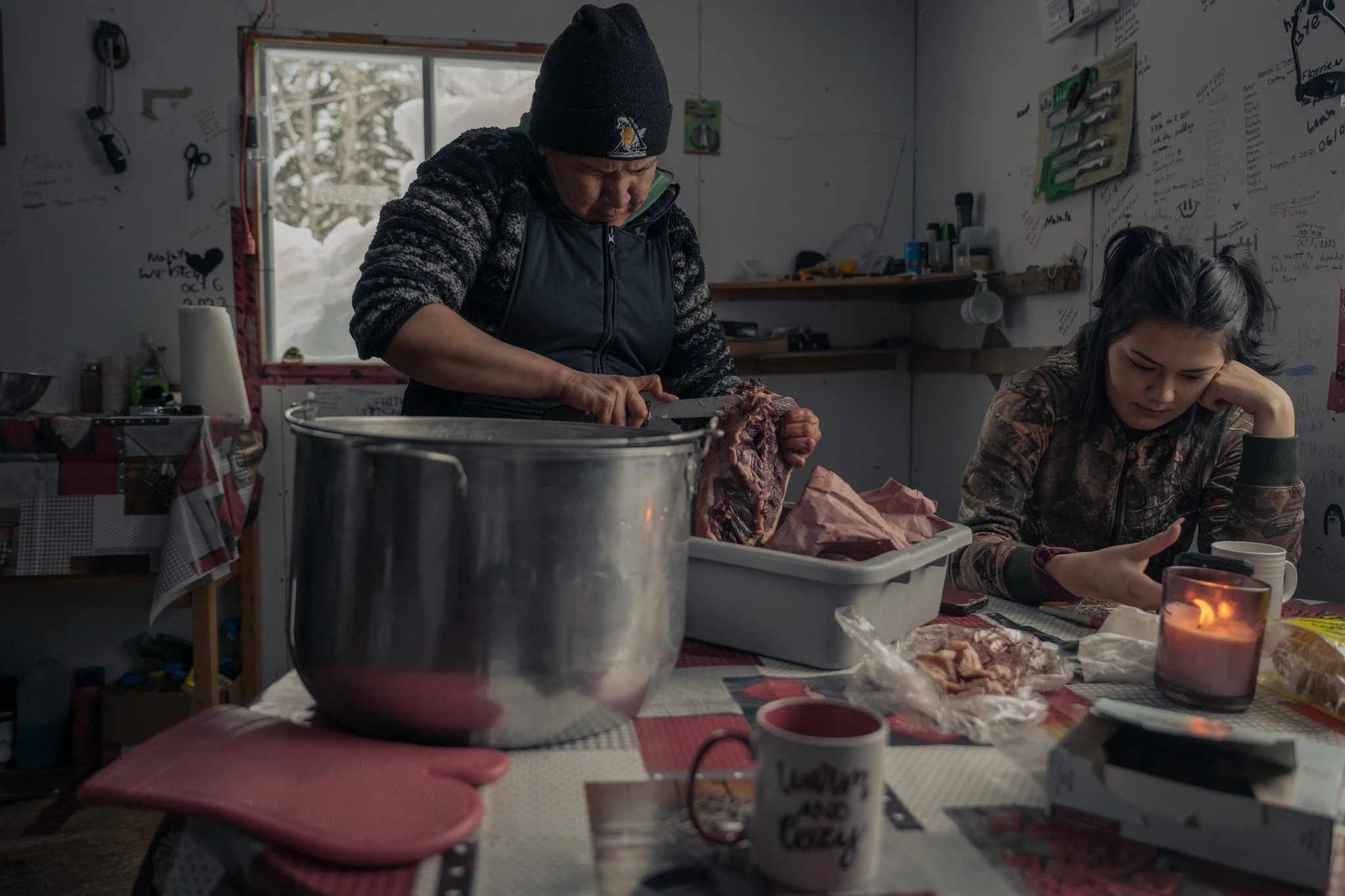 Preparing food together inside a cabin