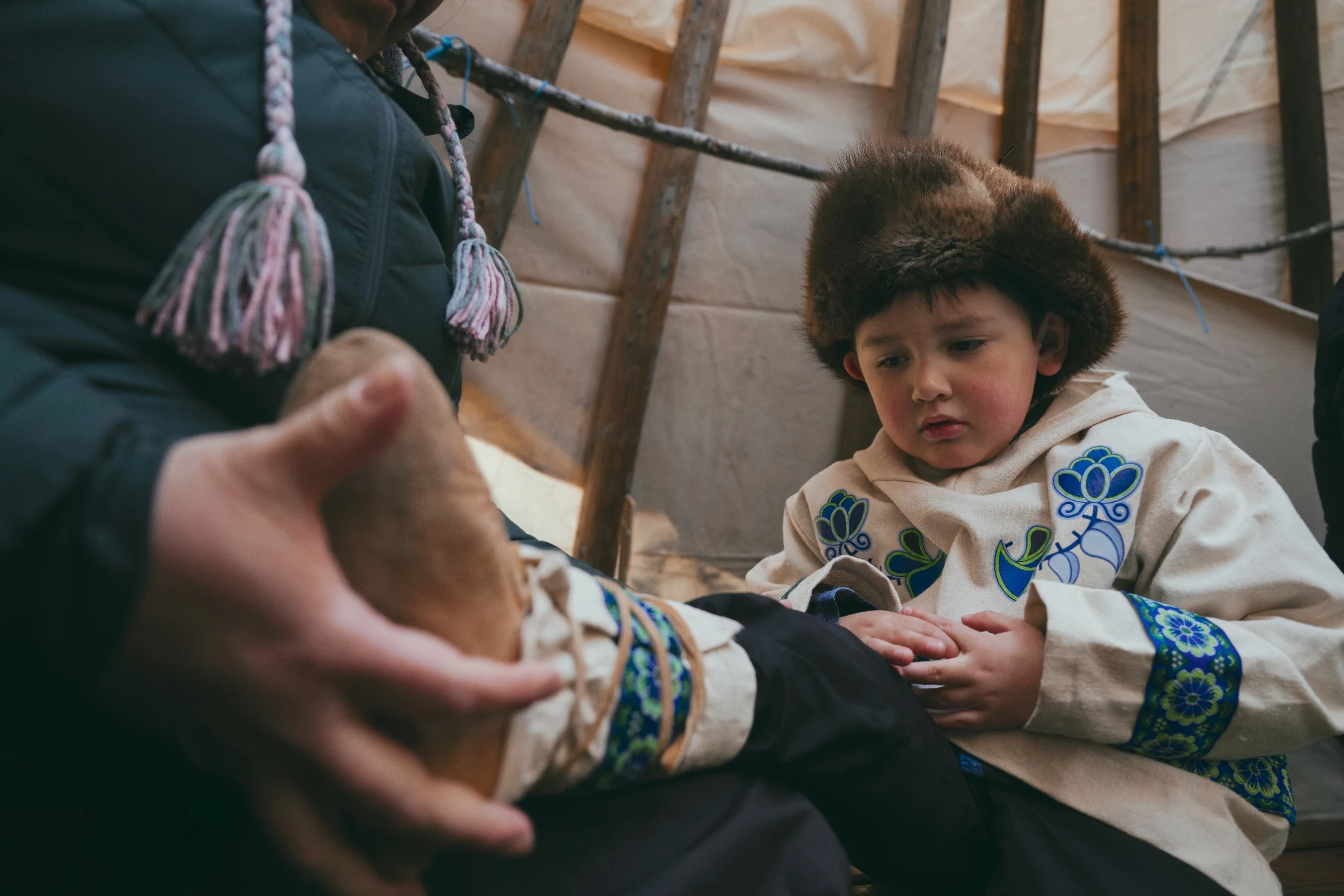 Child watching an adult inside a tent
