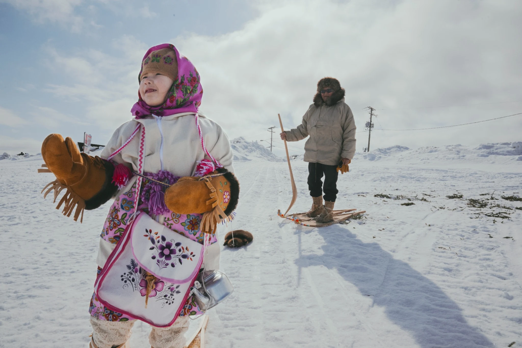 Child and elder on snowshoes